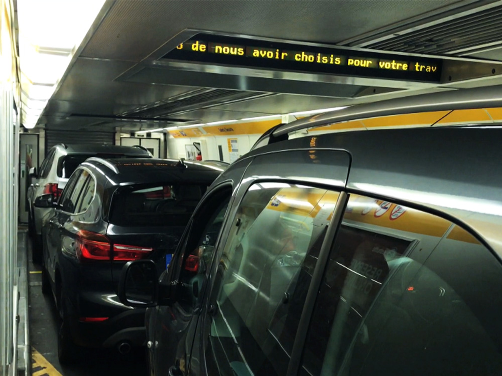 A close-up of cars in a French parking garage