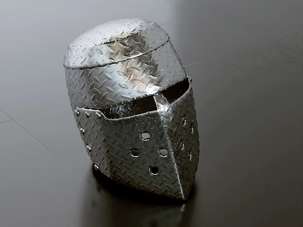 A medieval helmet sitting on a sleek grey floor. A face is reflected in the metal.