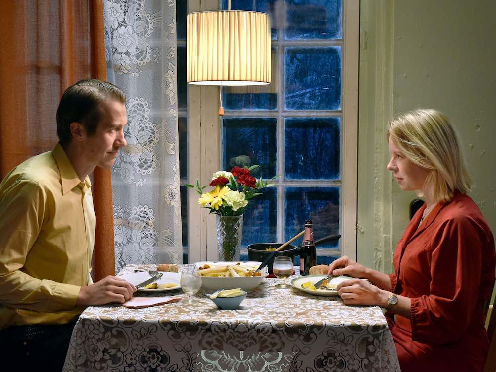 A couple have a semi-romantic dinner in their home